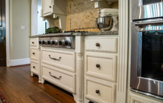 low view of kitchen with hardwood floors and custom cabinets and stove, steps for sanding cabinets