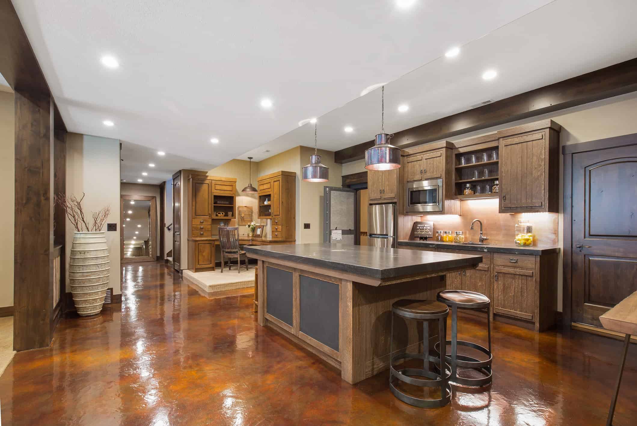 Second kitchen in basement with cabinetry and center island,